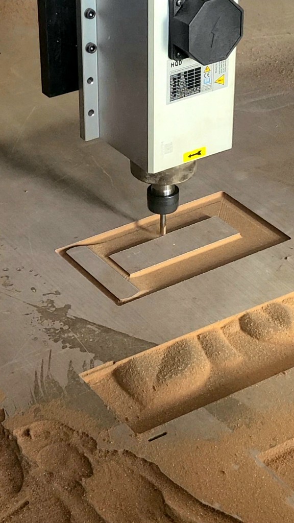 CNC machine precision-milling a custom mold prototype